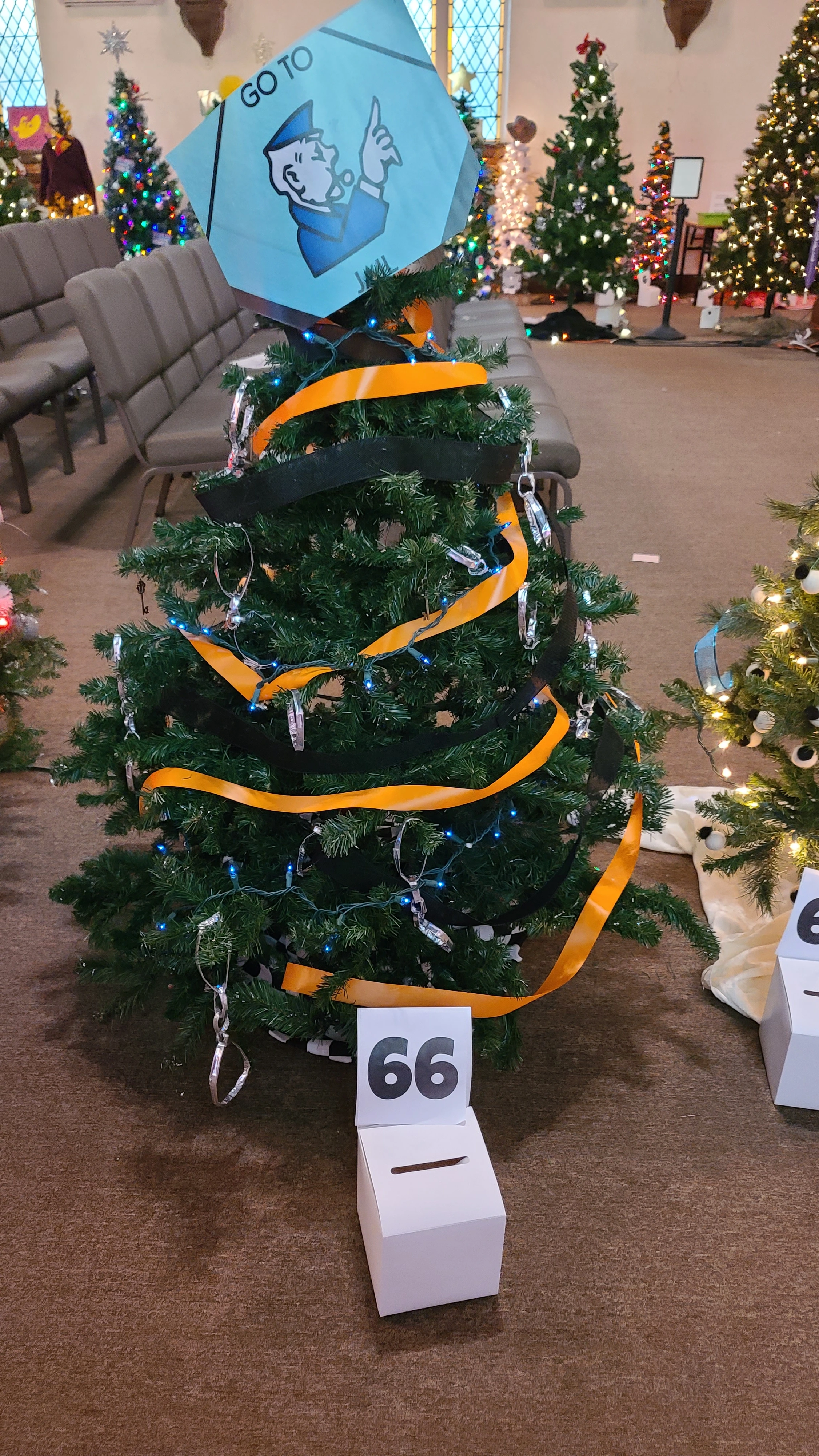 2022 archive photo of a tree with orange and black ribbons and a blue illustrated topper